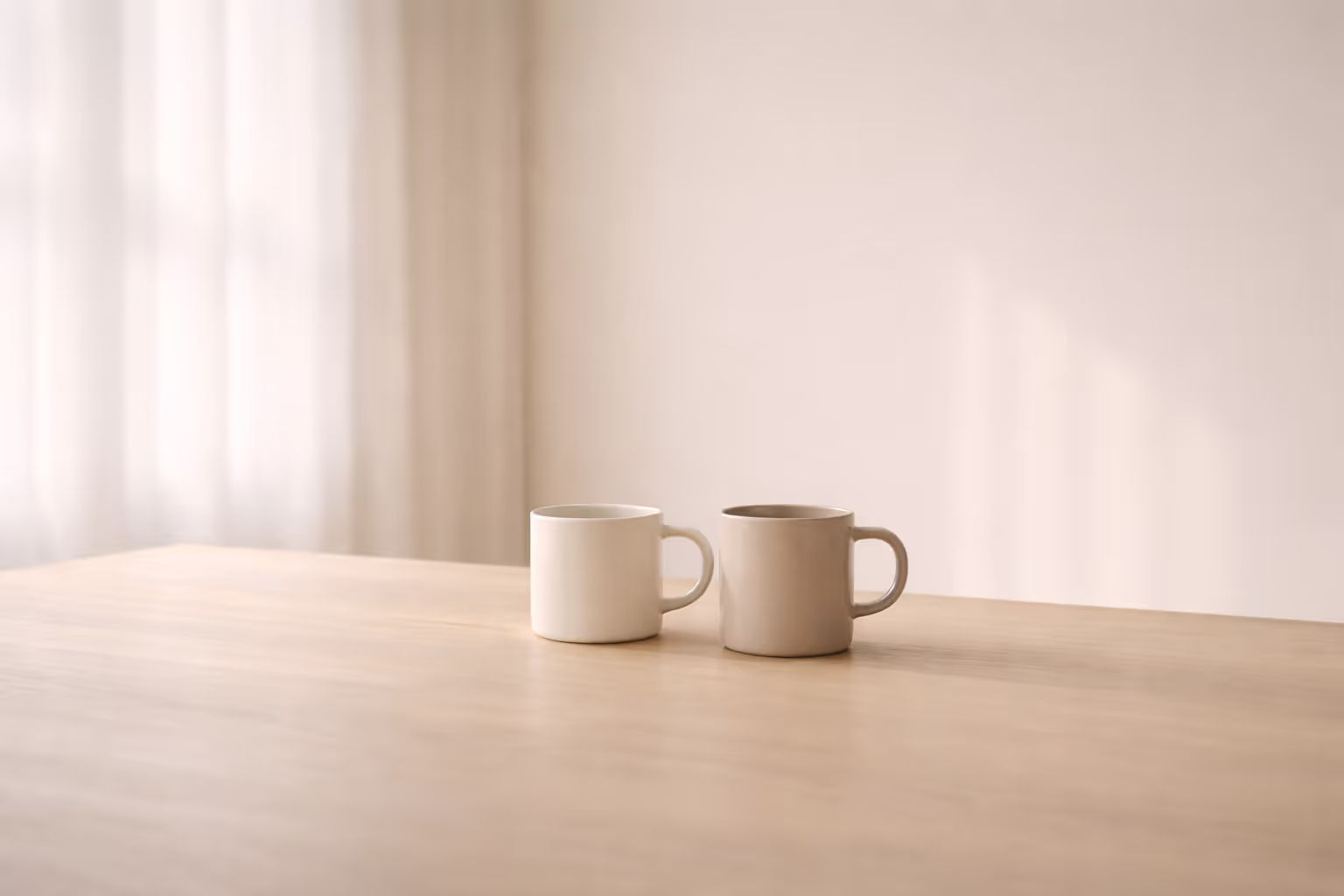 Two simple objects resting close together on a plain surface