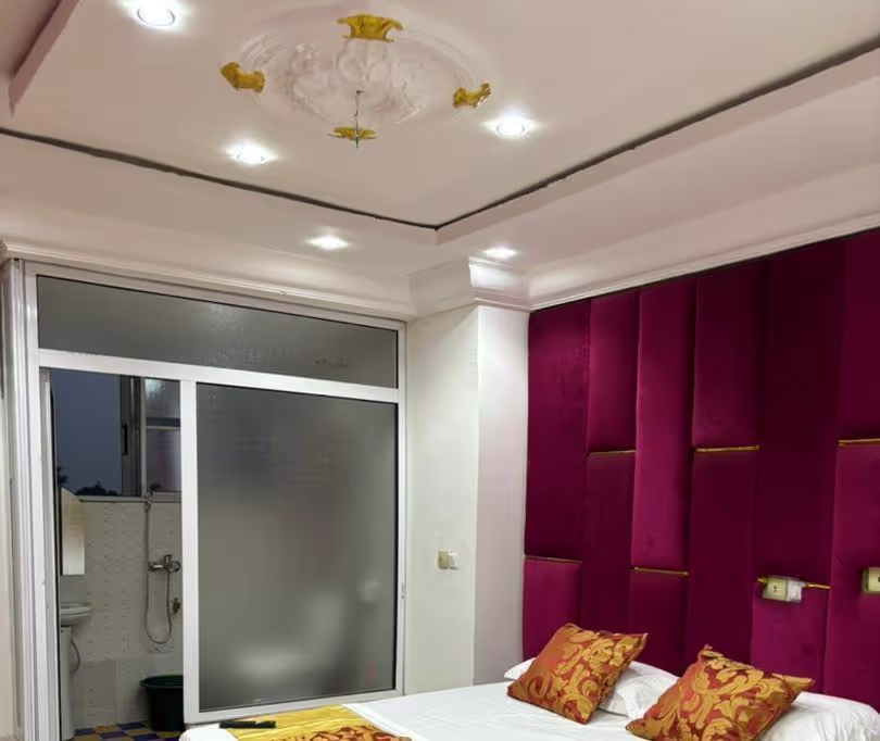 A cozy hotel room featuring two comfortable double beds, ideal for families or friends.