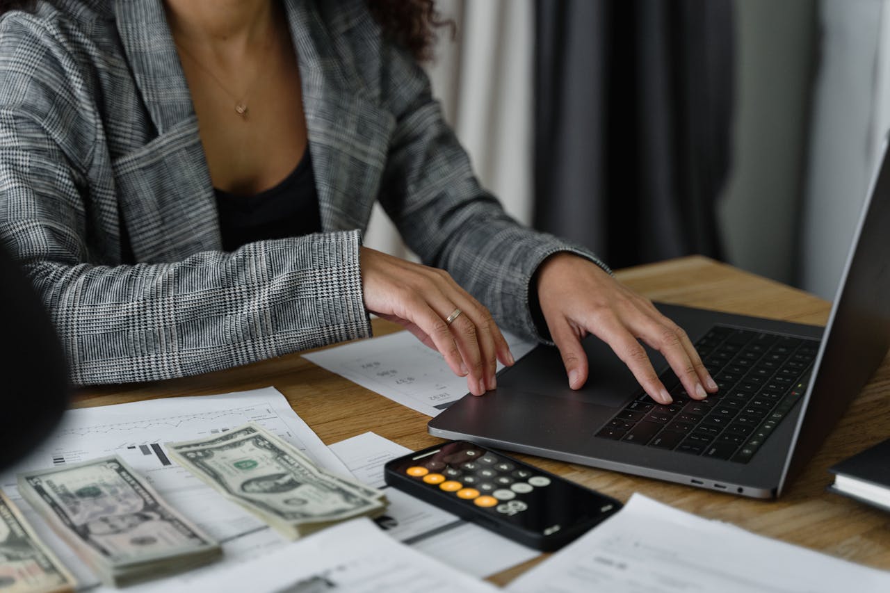 A woman reviewing her Amazon business performance on a laptop, visually identifying Amazon PPC agency red flags to protect her profit and ad spend.