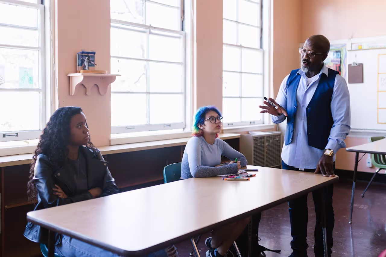 Faculty staff talking to student parents, illustrating how professional development and understanding policies support student parents college success.