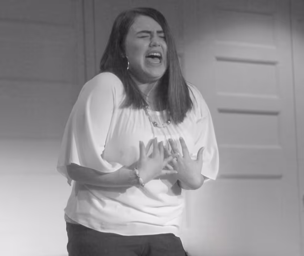 An actor delivering an emotional performance under a spotlight