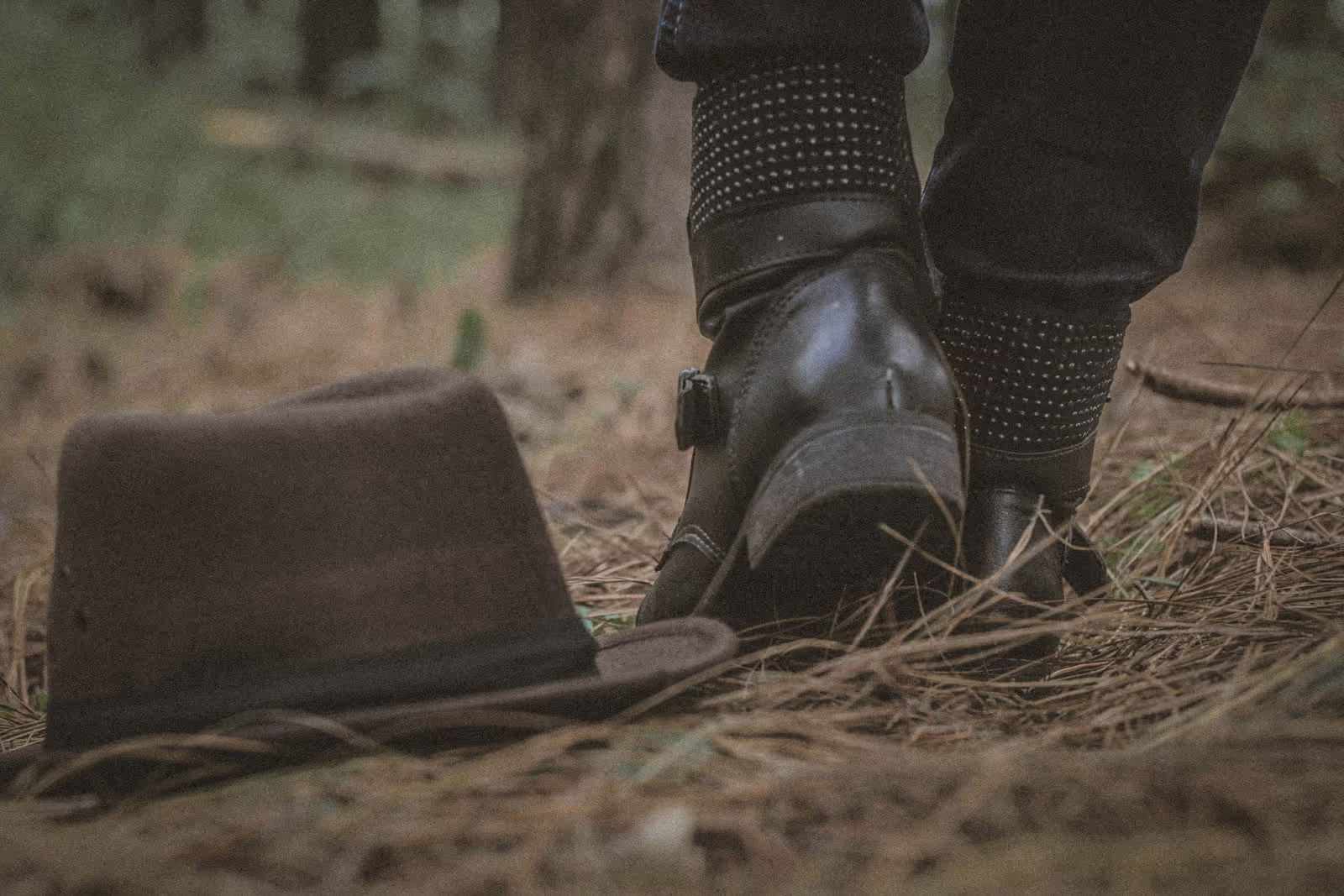 Classic cowboy boots and hat on a rustic wooden surface