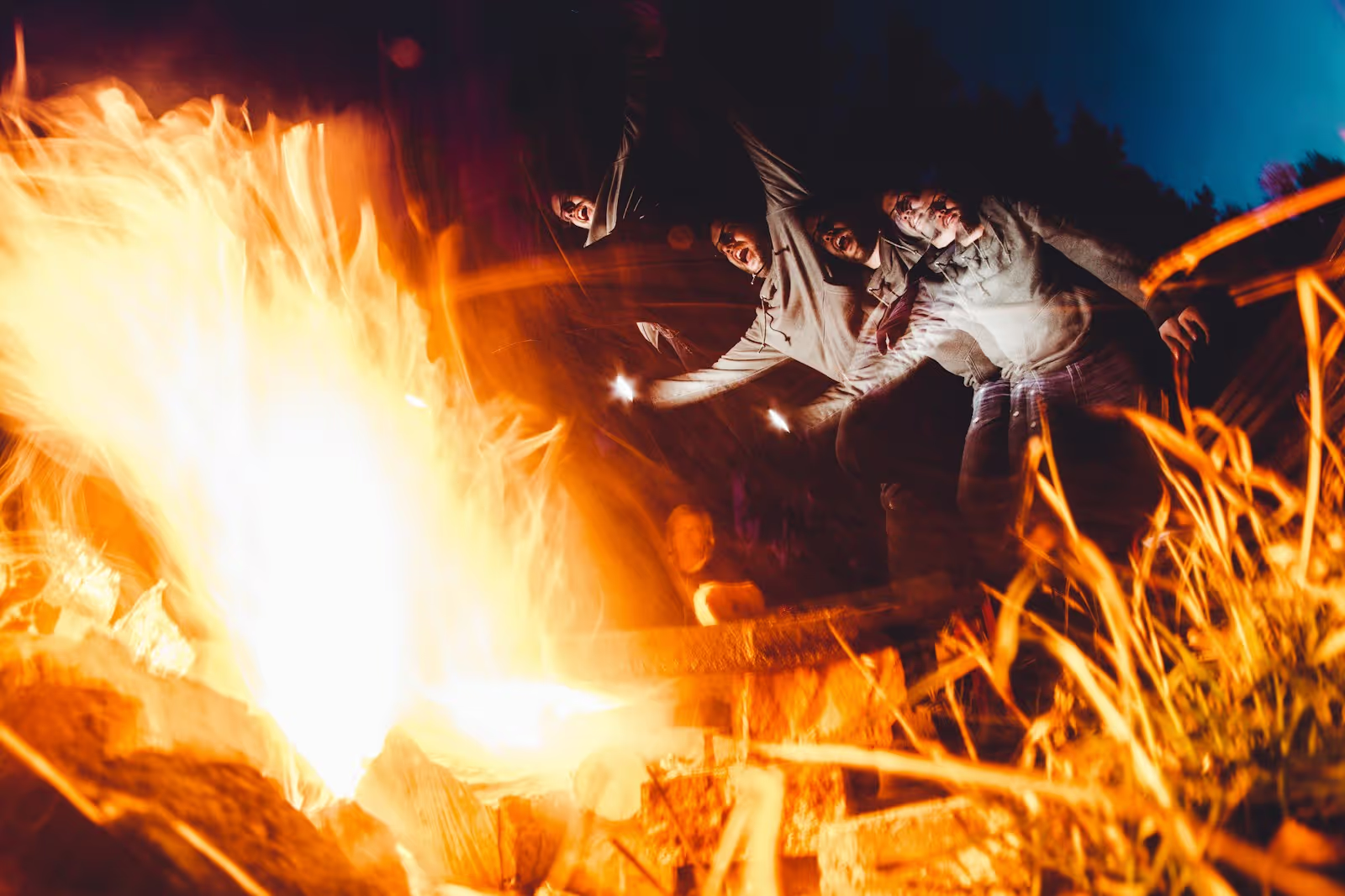 Friends enjoying s'mores around a campfire at the Wild West Fest