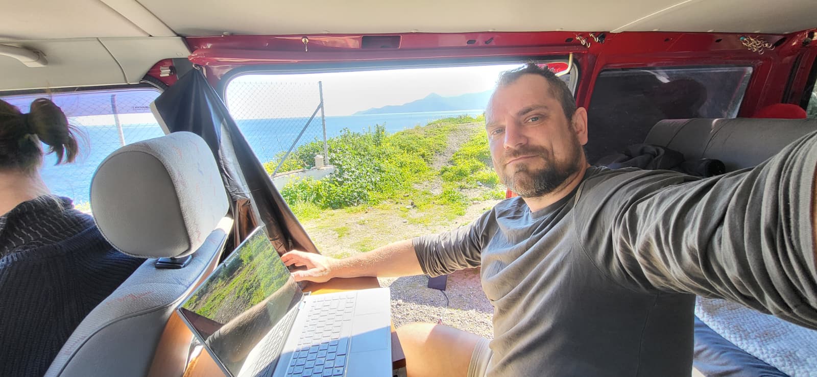 Konrad working on his laptop from the VW T4
