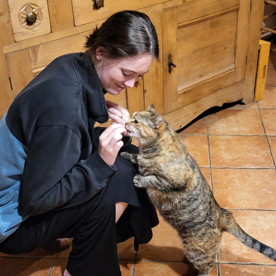 Caro feeding a cat in Lullin