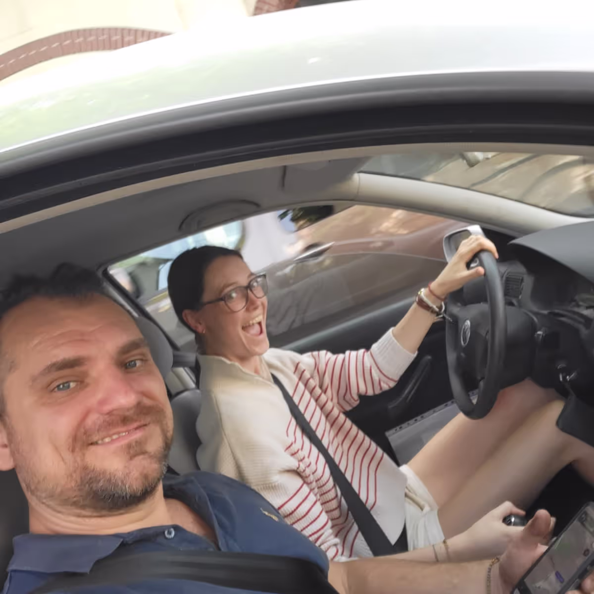 Konrad and Caro Driving in their VW Golf
