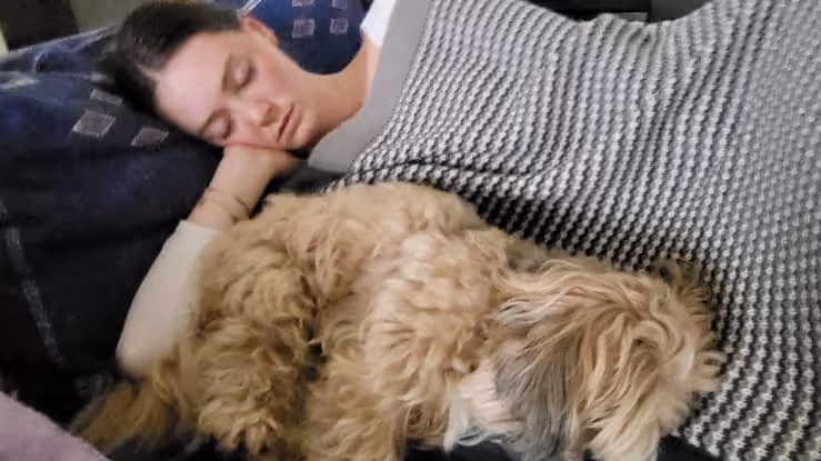 Caro falling asleep next to a dog we house sat in Luxembourg