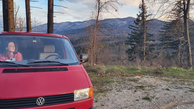 Caro sitting in our campervan on route to a new house sit