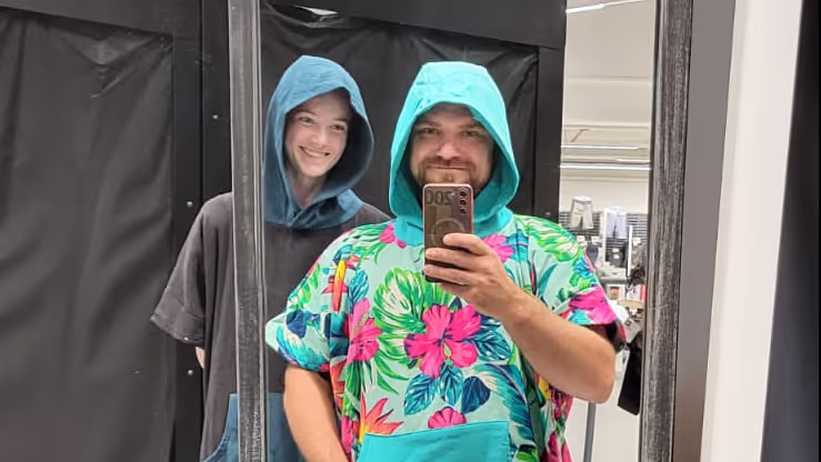 Konrad and Caro in Decathlon trying on beach towel suits