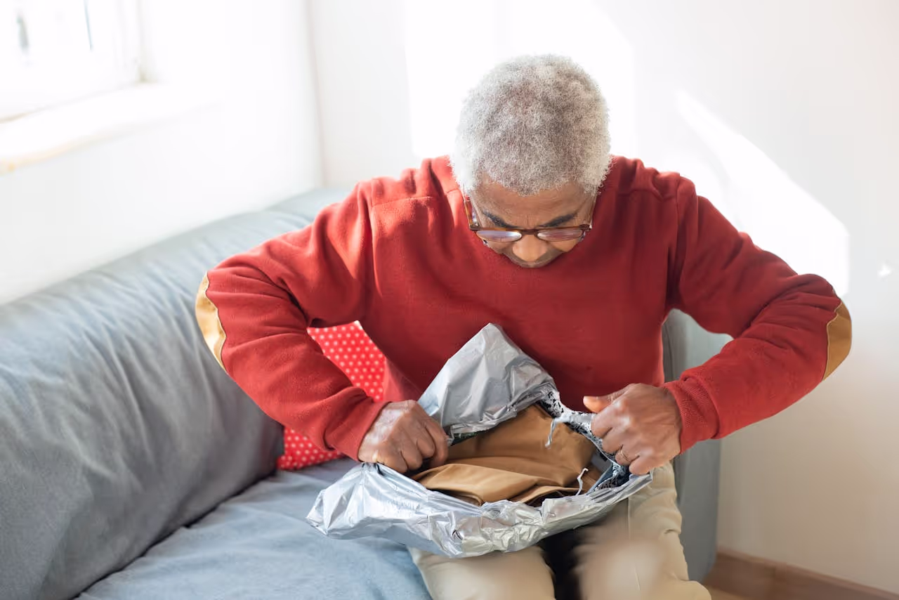 A person opening up a package