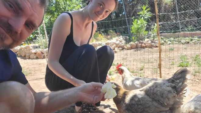 Konrad and Caro feeding chickens in Portugal