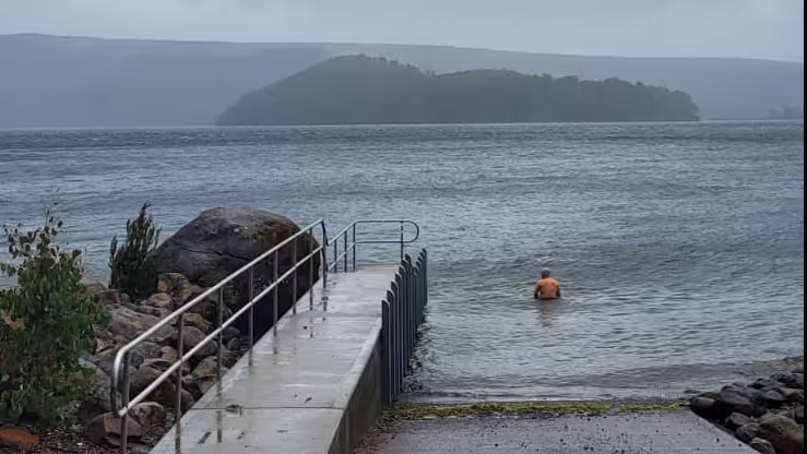 Konrad sitting in a lake in Tasmania