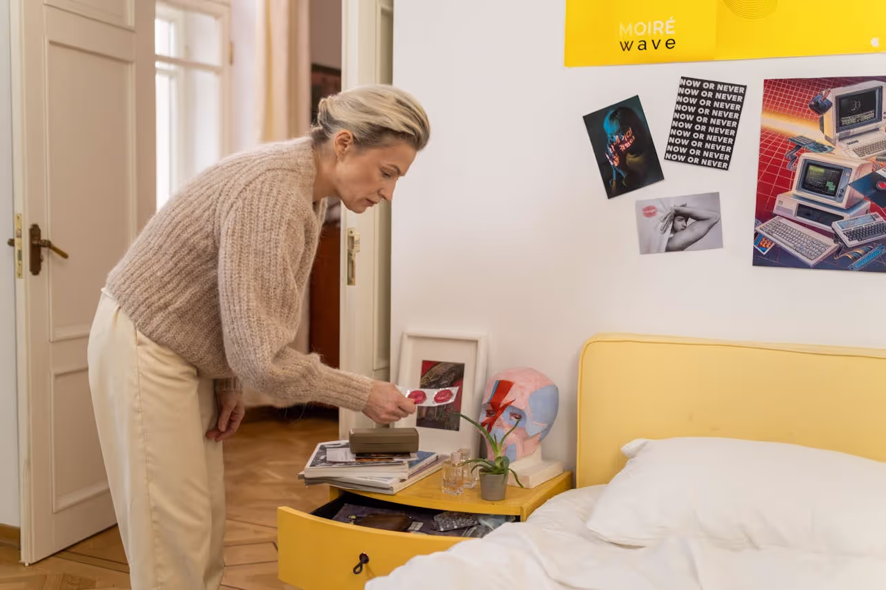 A person going through bedside drawers A person going through bedside drawers