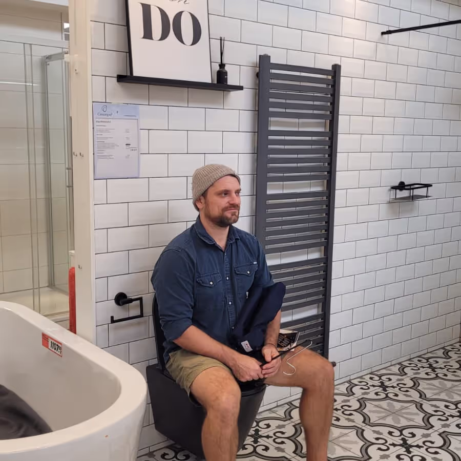 Konrad sitting on a toilet in a display toilet Konrad sitting on a toilet in a display toilet