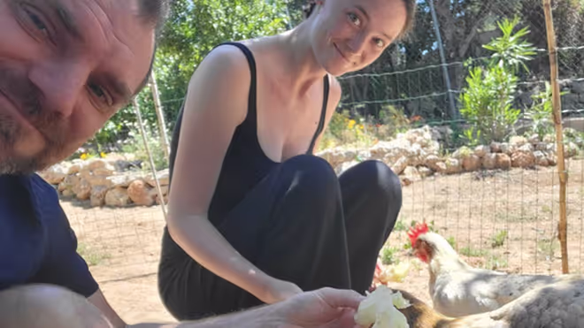 Konrad and Caro feeding chickens in Portugal Konrad and Caro feeding chickens in Portugal