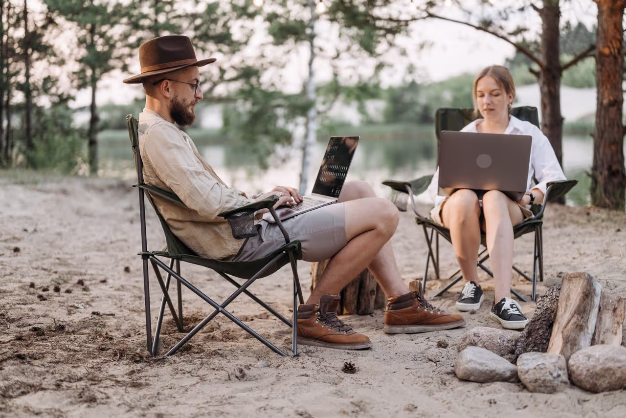 Couple working on their laptops remotely Couple working on their laptops remotely