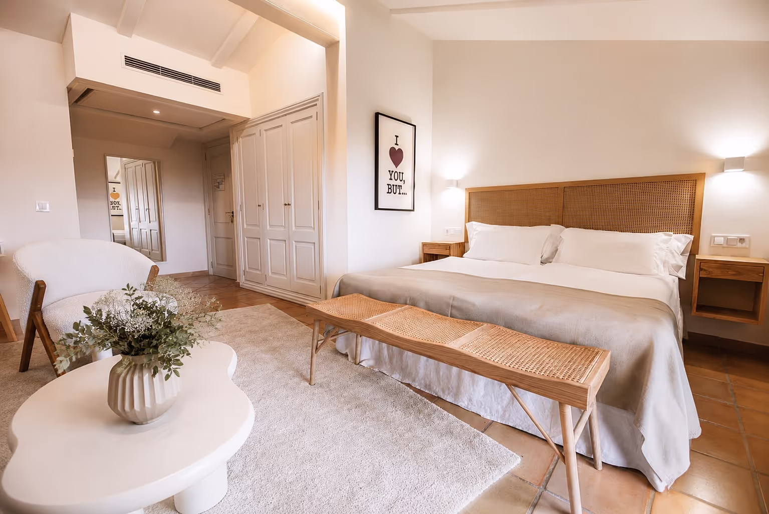 Luxurious king-size bed with pristine white linens and decorative pillows