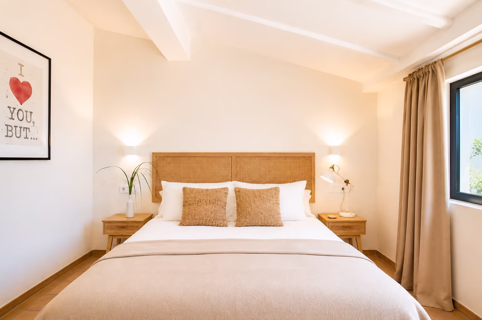 Luxurious king-size bed with pristine white linens and decorative pillows