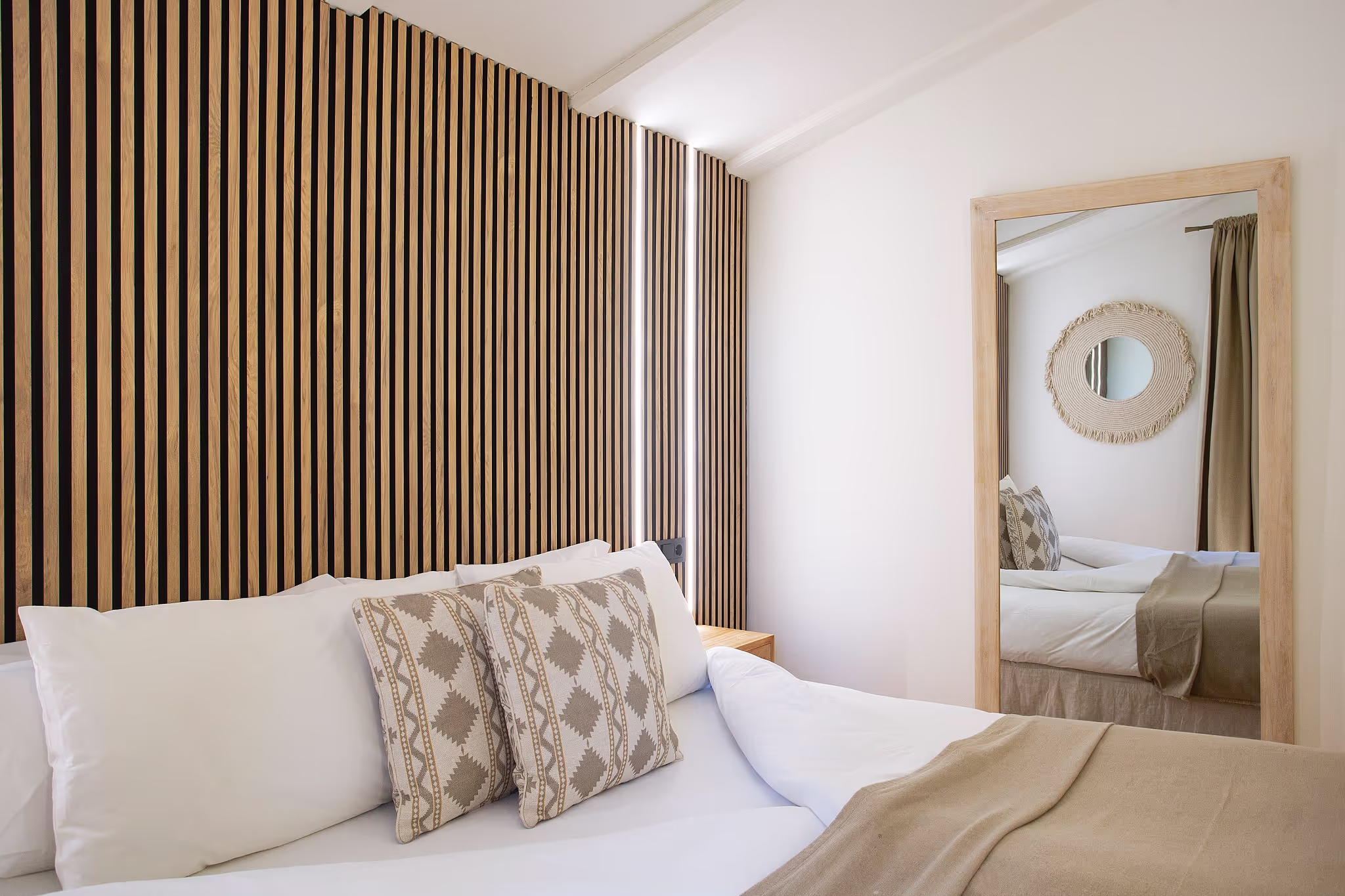 Luxurious king-size bed with pristine white linens and decorative pillows
