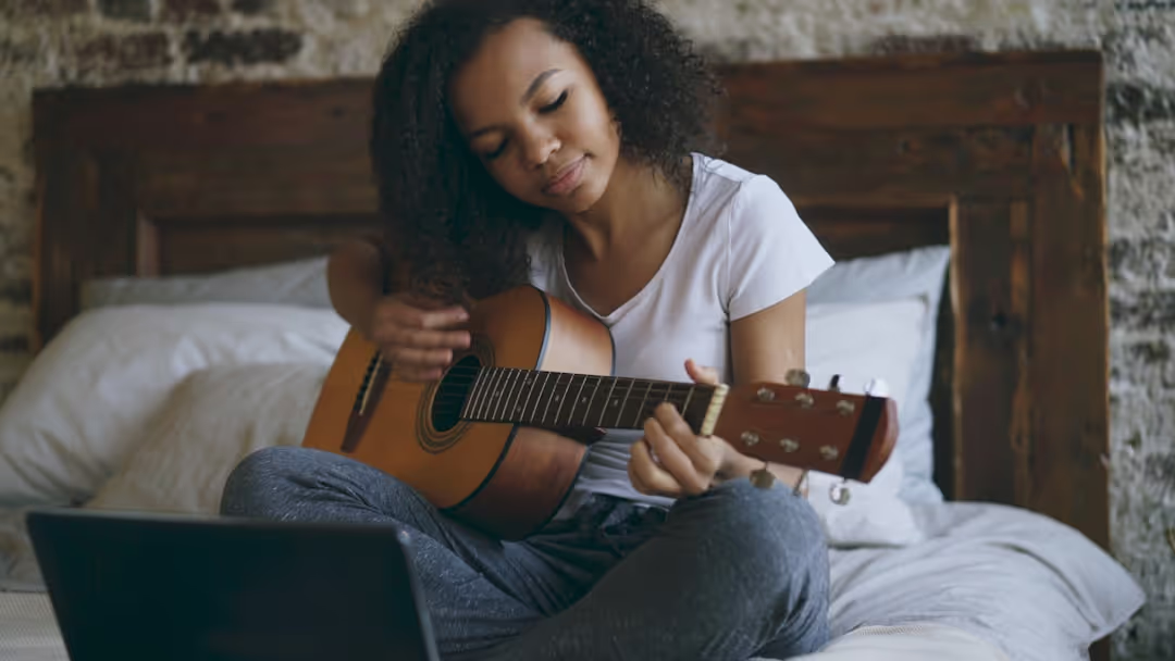 Anya Sharma playing guitar