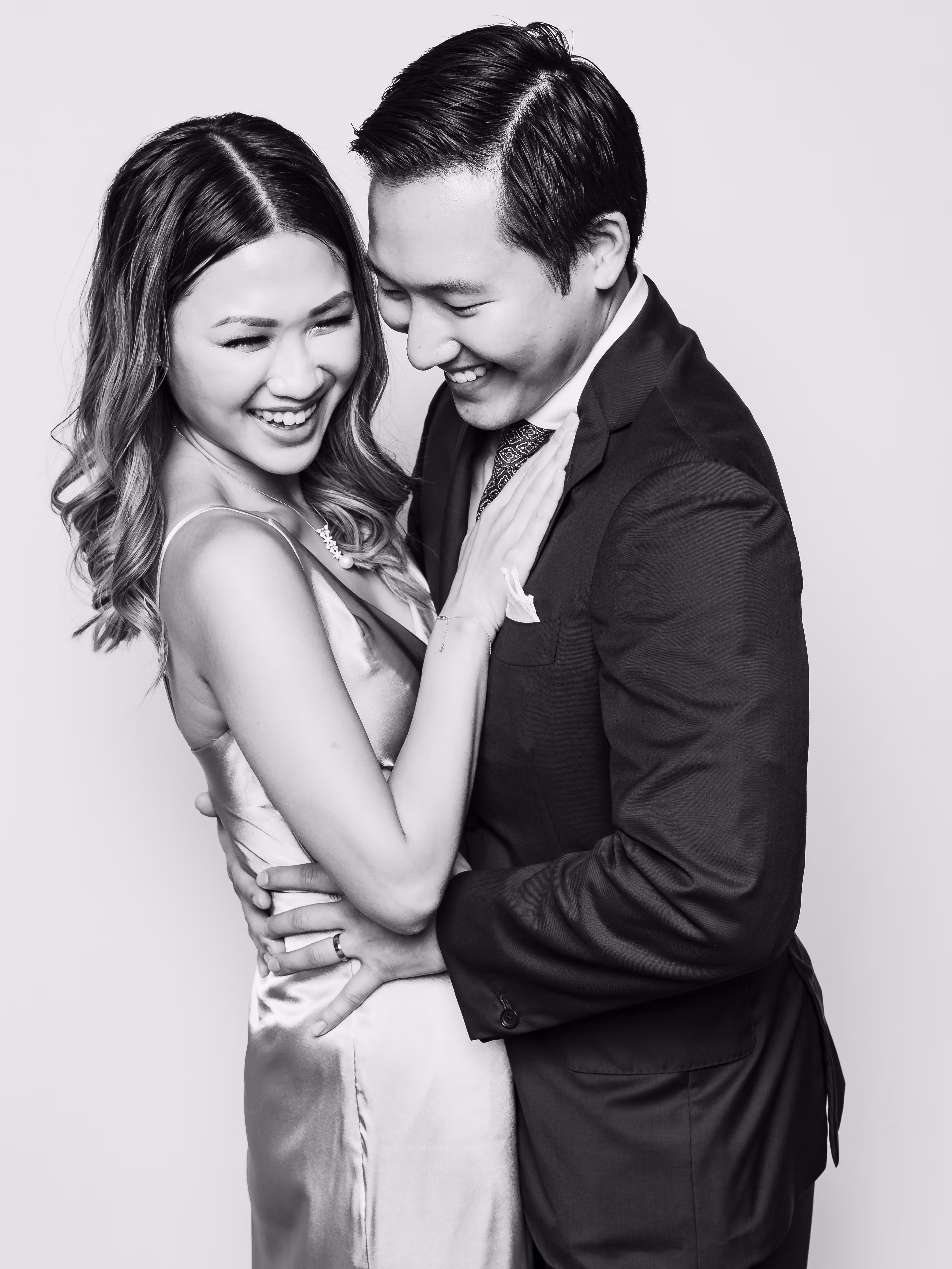 Engaged couple with genuine laughs for their photobooth